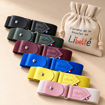 Six ceintures enfant Libelté noire, olive, bordeaux, bleu électrique, jaune et rose pastel, disposées avec leur pochon réutilisable.
