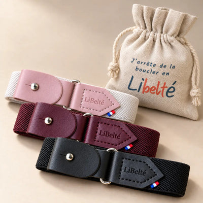 Trois ceintures enfant Libelté rose pastel, bordeaux et noire, présentées avec leur pochon réutilisable.